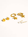 Set of gold and pearl earrings on a white background