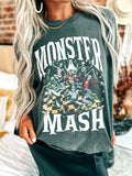 Person wearing a green t-shirt with 'Monster Mash' graphic design.